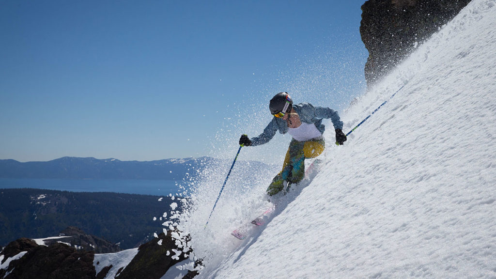A skier rips through soft snow on a bluebird Lake Tahoe day. 