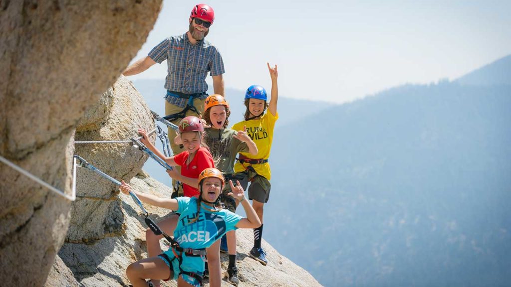 Kids climb the iconic Tram Face with Alpenglow Expeditions.